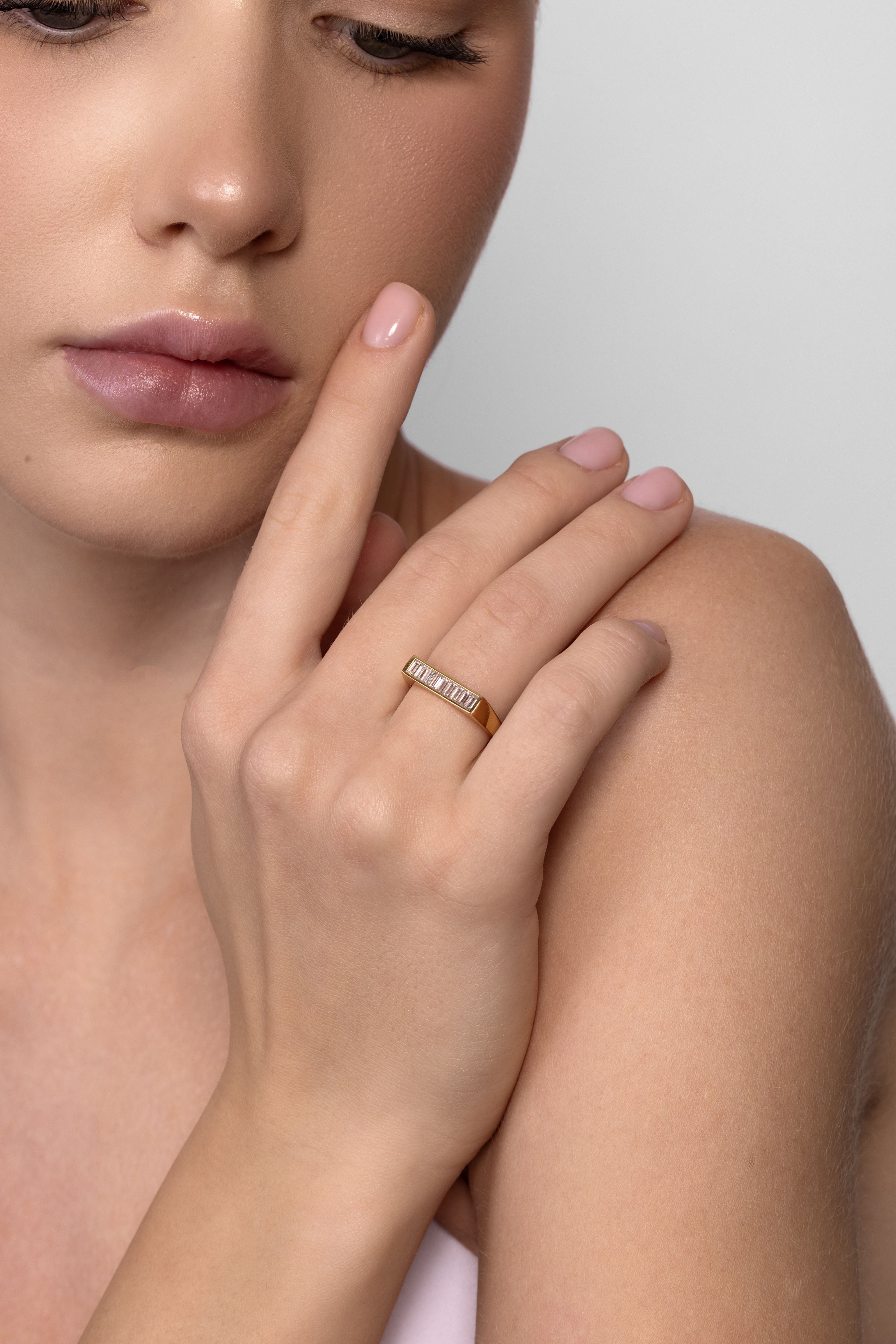 Baguette Bezel Set ring in 18k gold worn on hand showing baguette diamonds, unisex jewelry NIK Jewellery Canada