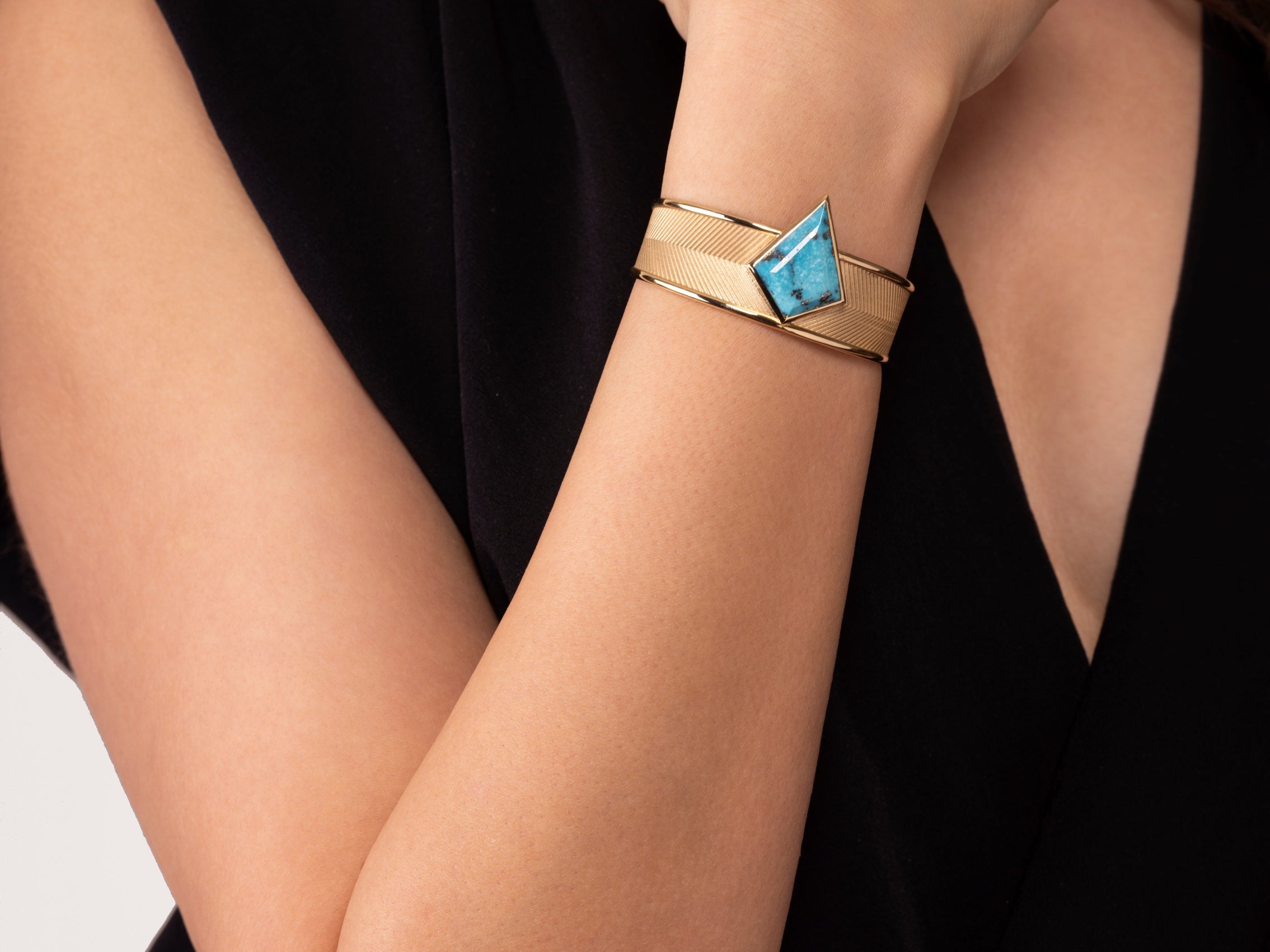 DENA cuff bracelet in 18k gold with Persian turquoise worn on wrist, showcasing unisex jewelry statement piece styling, NIK Jewellery Canada
