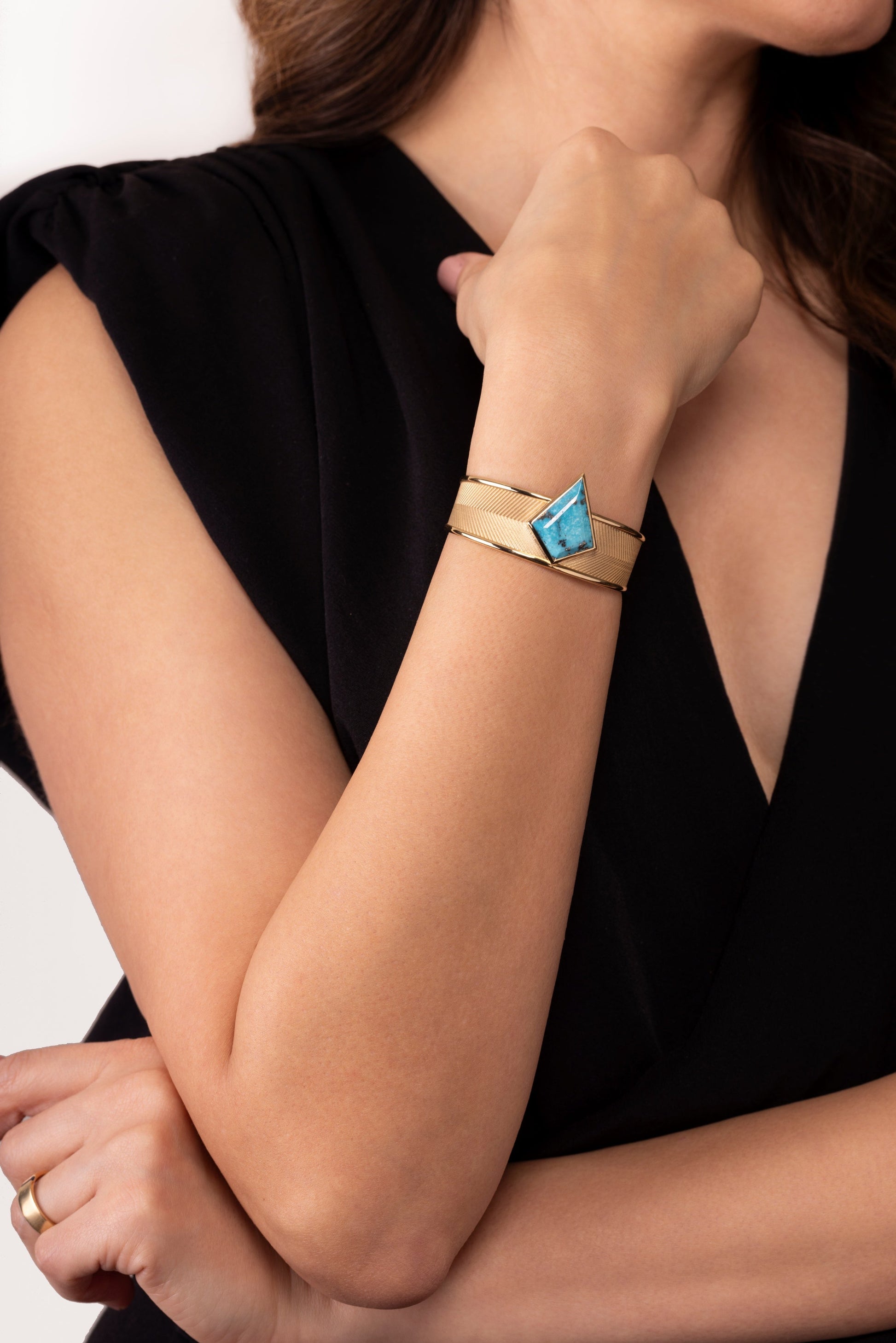 DENA cuff bracelet in 18k gold with Persian turquoise worn on wrist, showcasing unisex jewelry statement piece styling, NIK Jewellery Canada