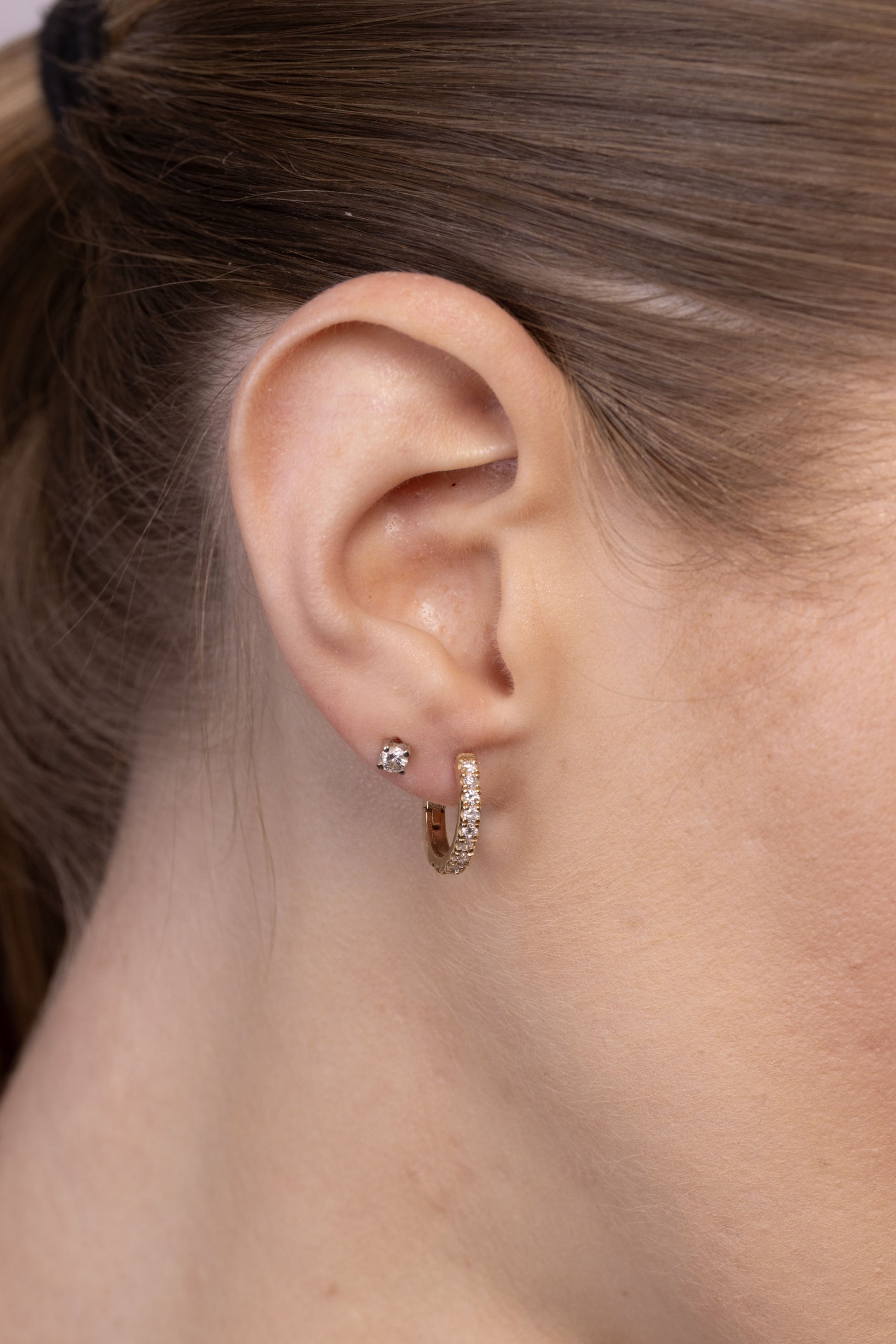 Nik Jewellery 14K gold diamond pavé hoop earring worn on ear, showing 14.5 mm size and fit.