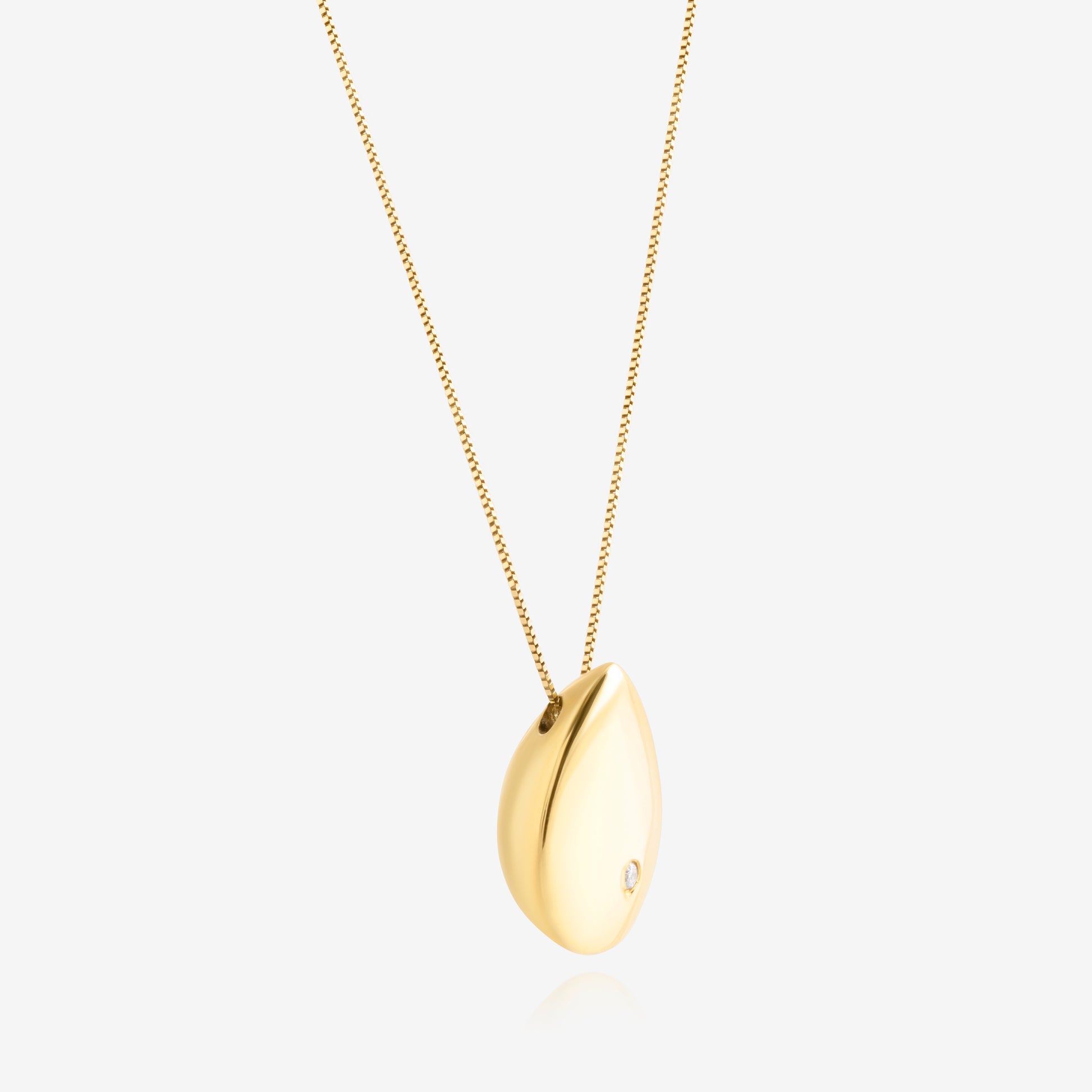 Nik Jewellery Astra gold vermeil pear diamond pendant necklace, angled view showing smooth domed profile.