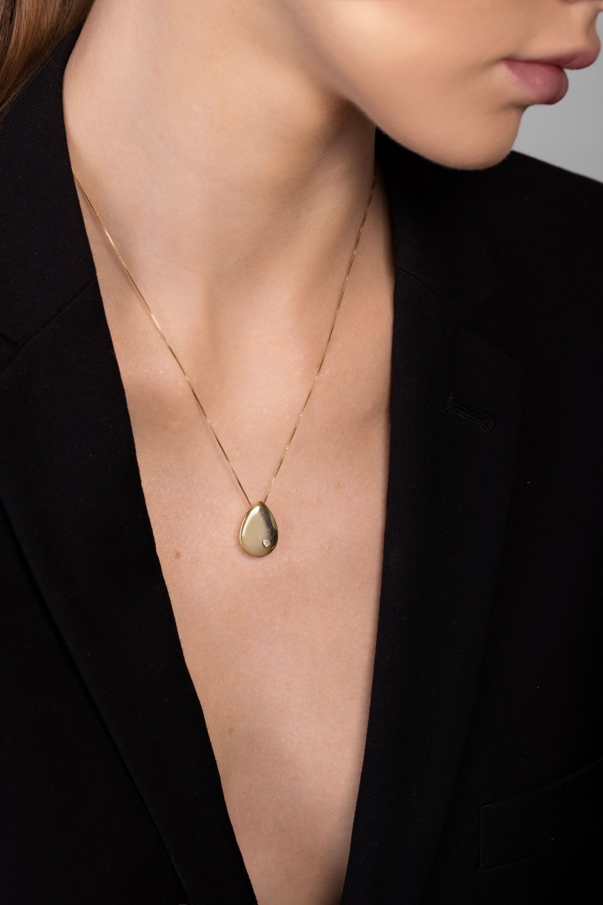 Nik Jewellery Astra gold vermeil pear diamond pendant necklace worn on neck, showing size and length.