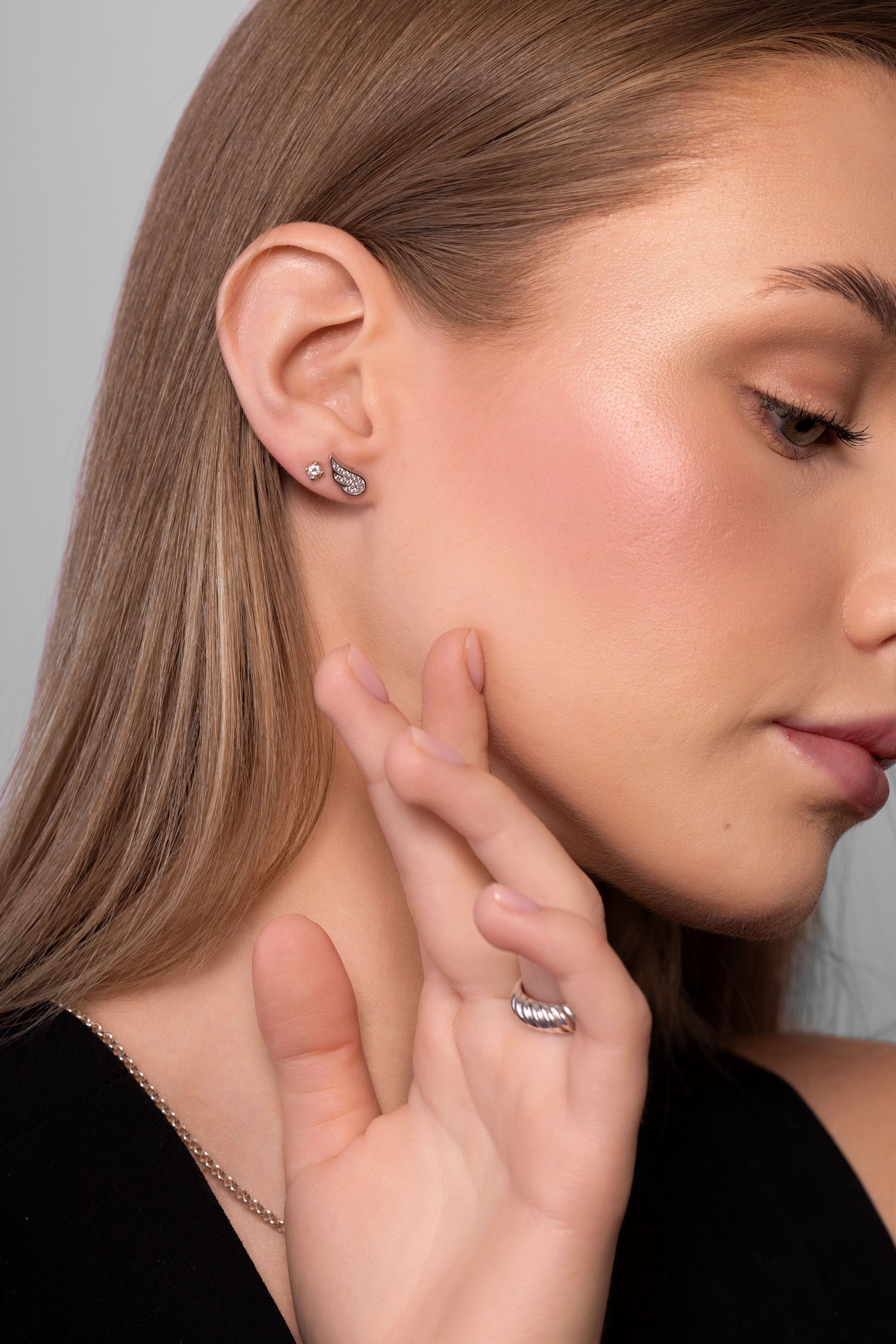 Nik Jewellery Celeste 14K white gold lab-grown diamond wing stud earring worn on ear, showing scale and fit.