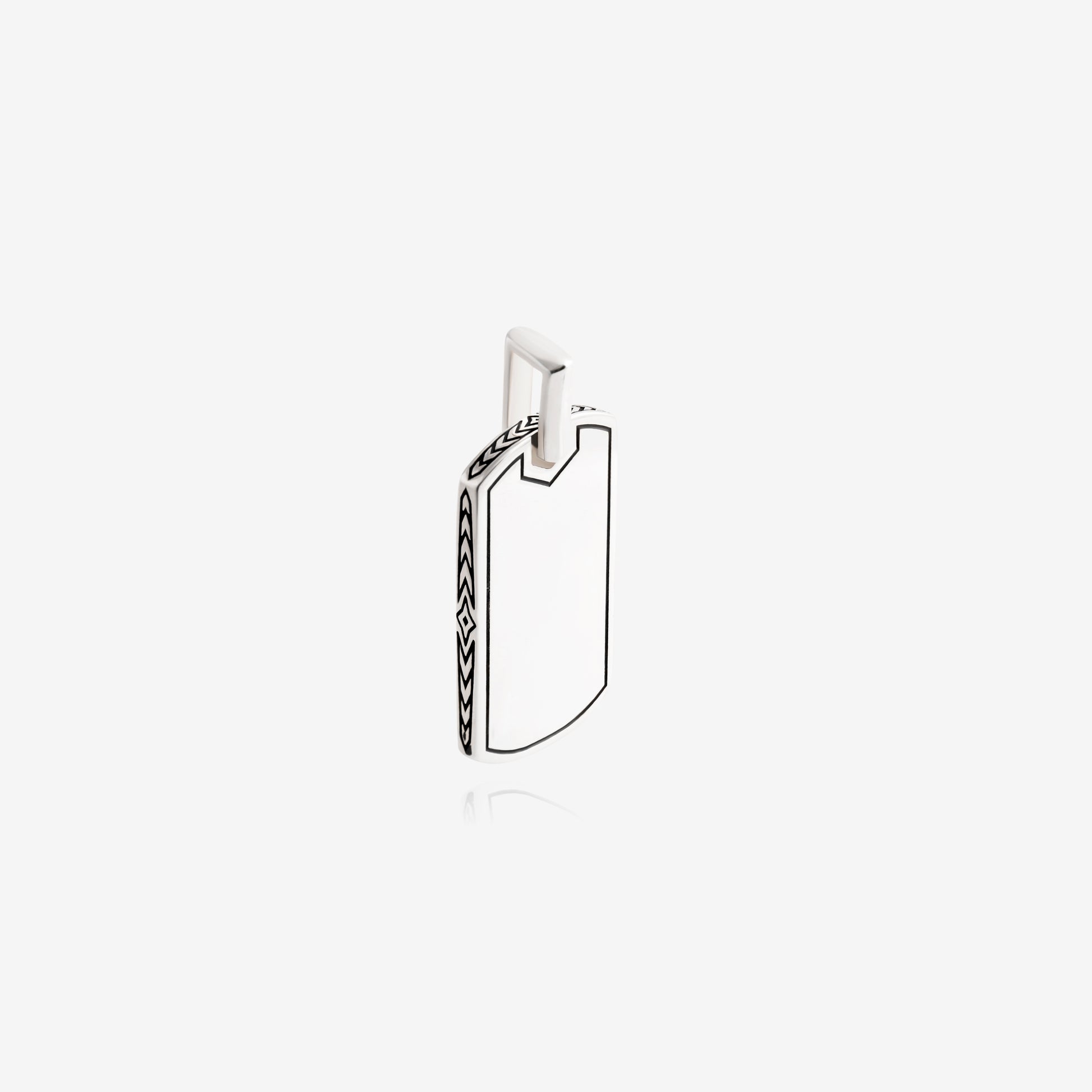 Nik Jewellery silver tag pendant side angle showing engraved arrow and diamond pattern along the edge.