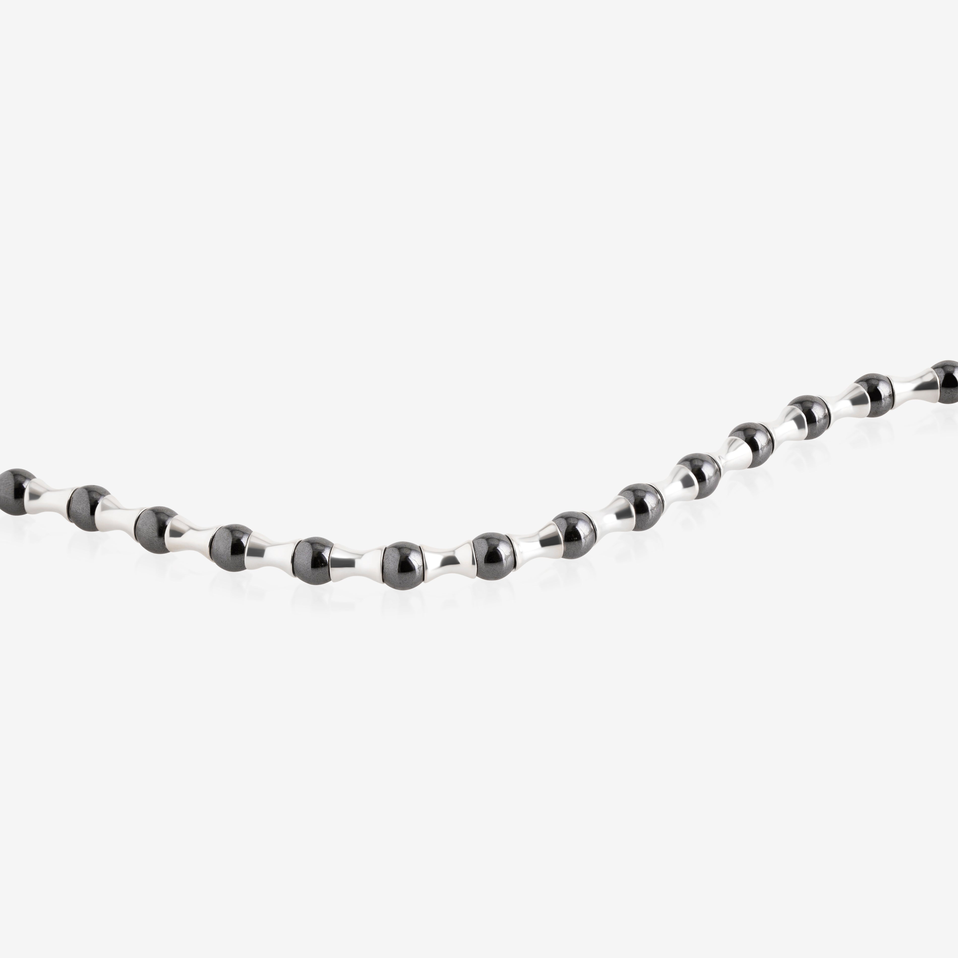 Nik Jewellery hematite axis men’s bracelet close-up, showing black hematite beads and tapered silver segments in a repeating pattern.