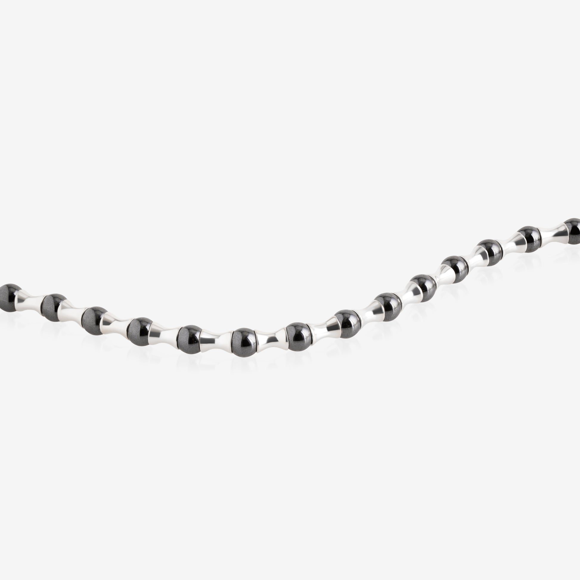 Nik Jewellery hematite axis men’s bracelet close-up, showing black hematite beads and tapered silver segments in a repeating pattern.