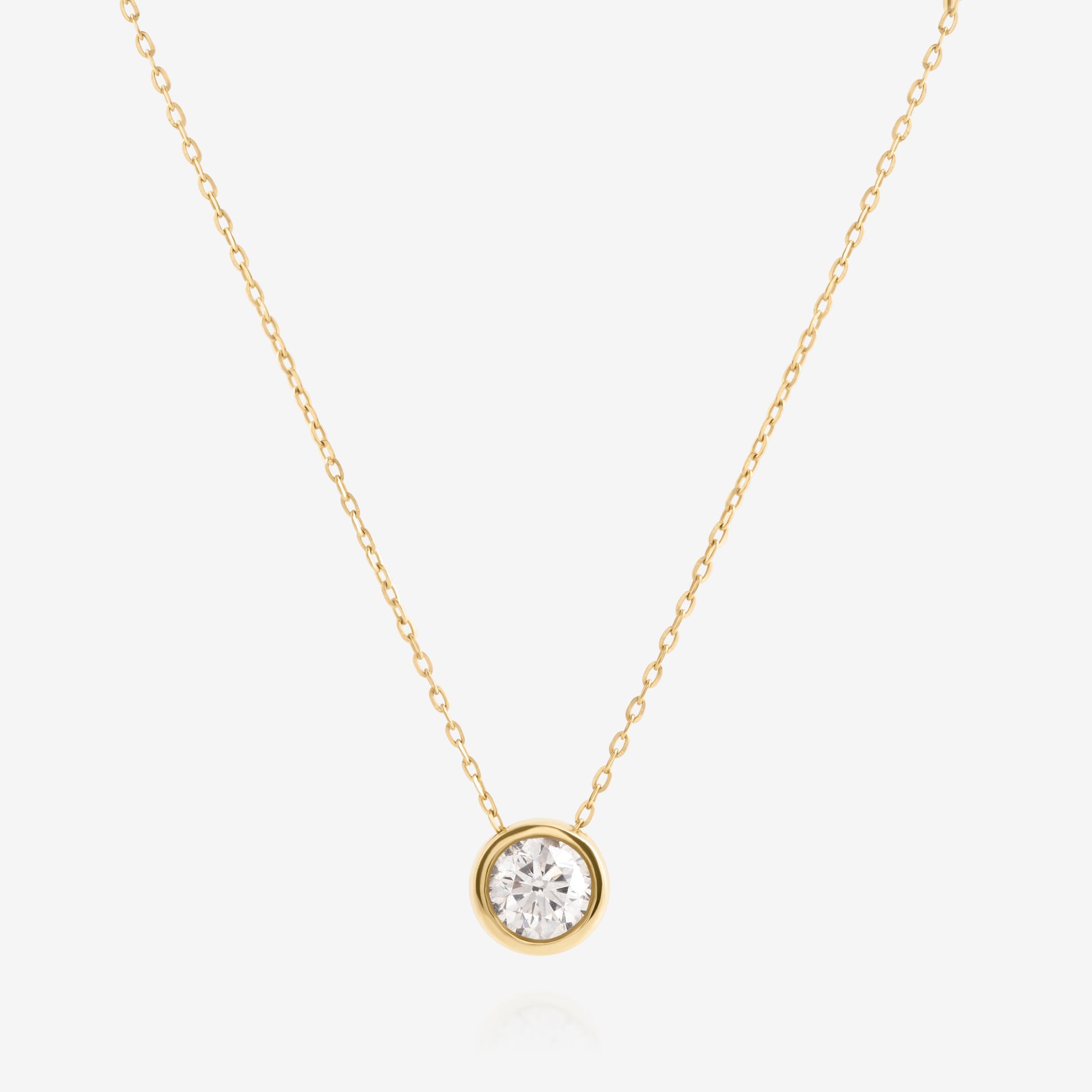 Nik Jewellery Lumen 18K yellow gold necklace with 0.57ct round bezel-set diamond, full front view.