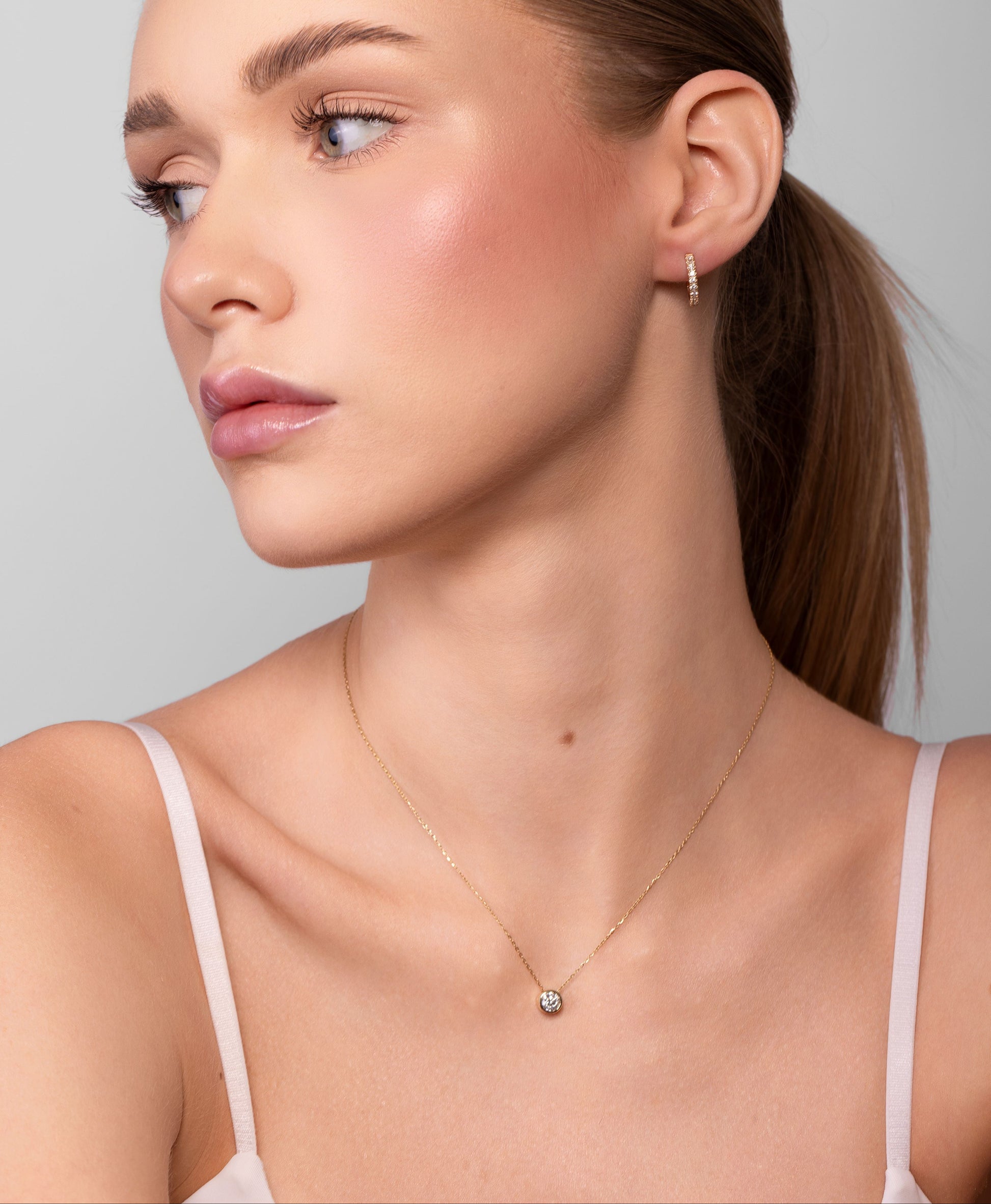 Nik Jewellery Lumen 18K gold bezel diamond necklace worn on neck with 16 inch chain, showing size and placement.