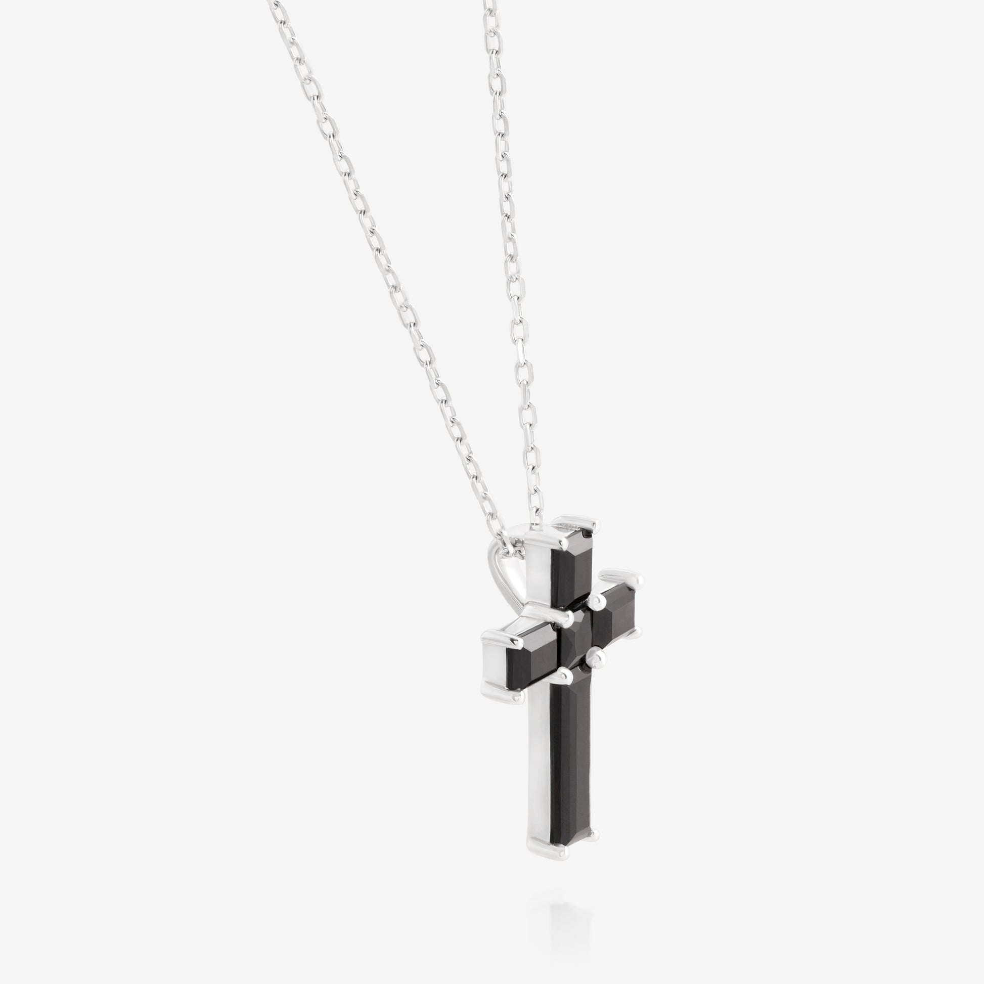 Nik Jewellery Noir sterling silver black baguette cross necklace, angled view showing prong setting and side profile.