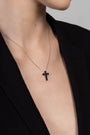 Nik Jewellery Noir black baguette cross necklace worn on neck with black blazer, showing size and placement.