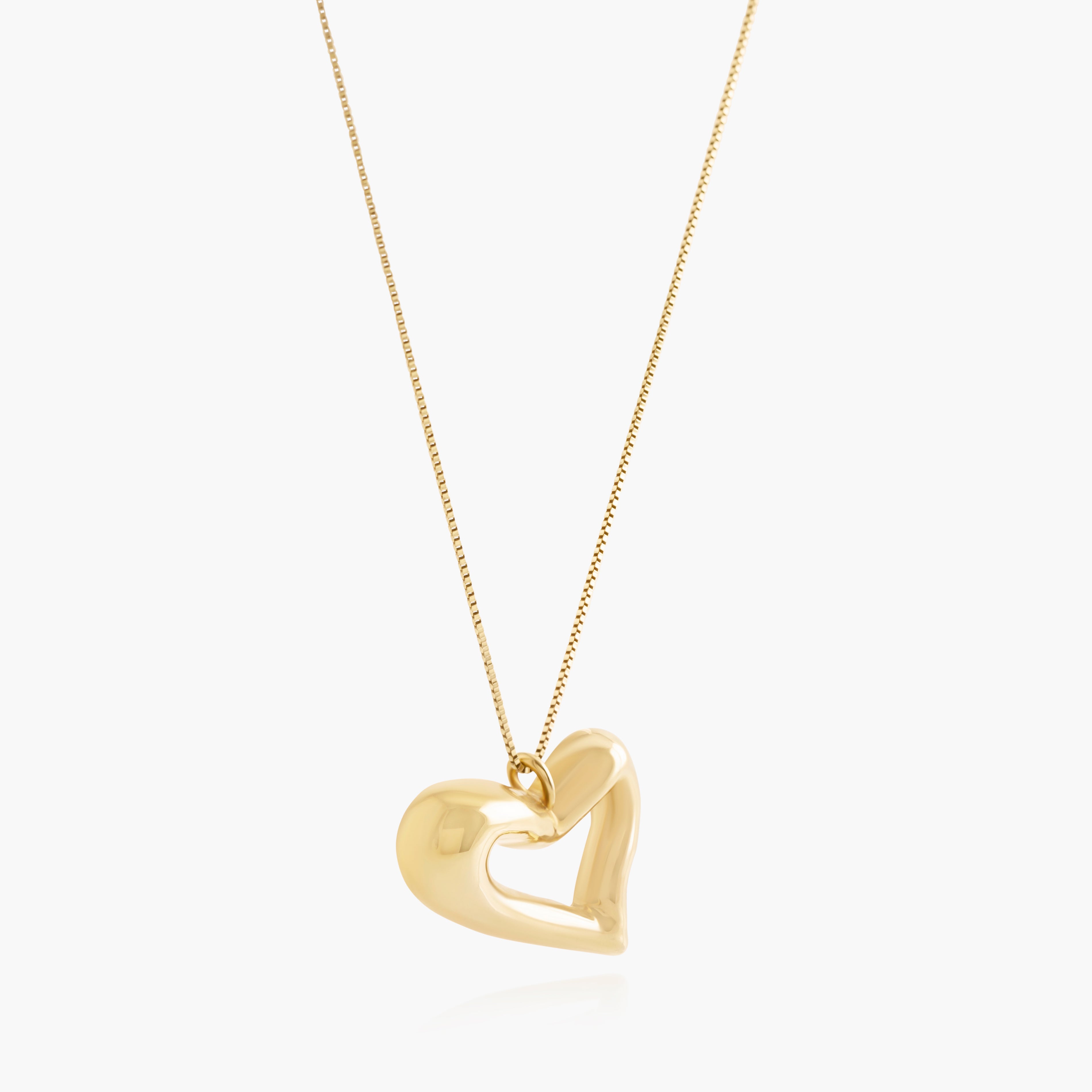 Nik Jewellery Seren gold vermeil open heart pendant necklace, angled view showing sculpted open heart shape.