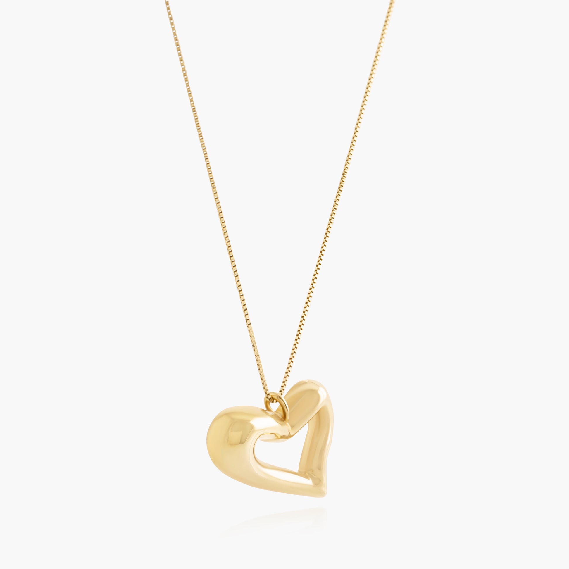 Nik Jewellery Seren gold vermeil open heart pendant necklace, angled view showing sculpted open heart shape.
