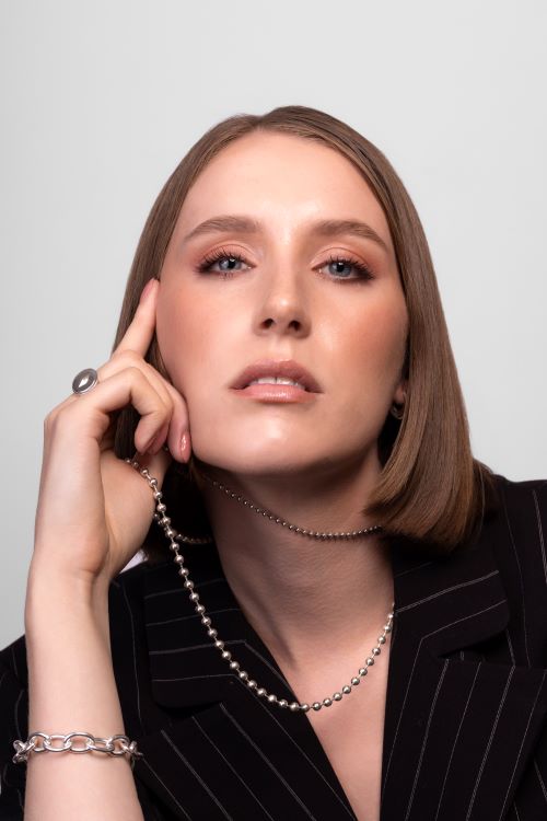 Nik Jewellery silver cable chain bracelet on woman model's wrist showing fit and size.