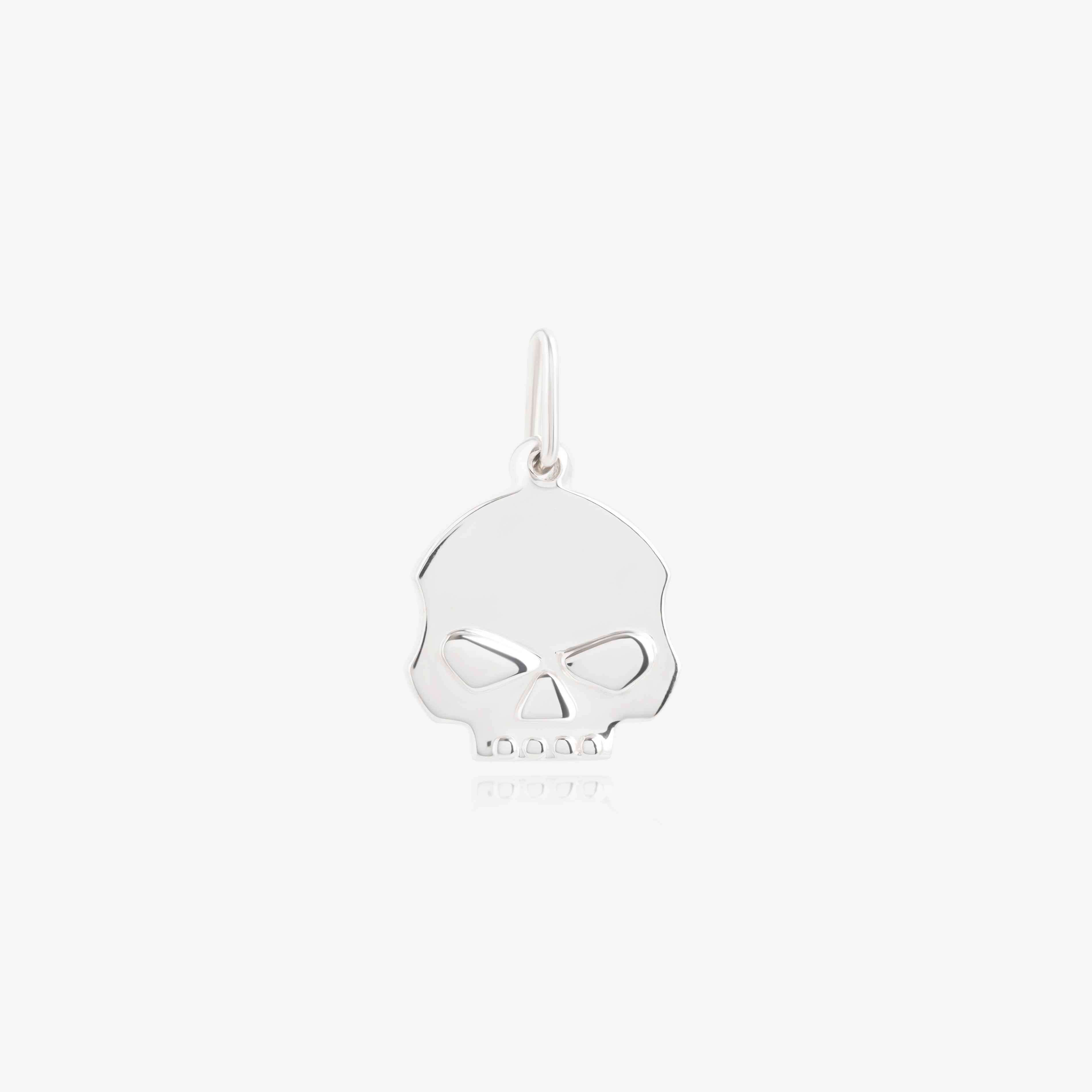 Nik Jewellery silver skull pendant close-up front showing detailed eye sockets, nose bridge, and teeth carving.