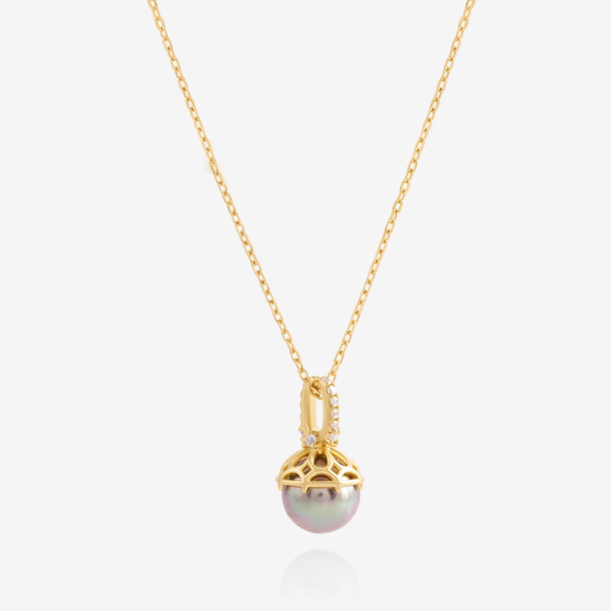 Nik Jewellery Solara 18K gold pearl diamond pendant necklace, angled view showing openwork cap and diamond details.