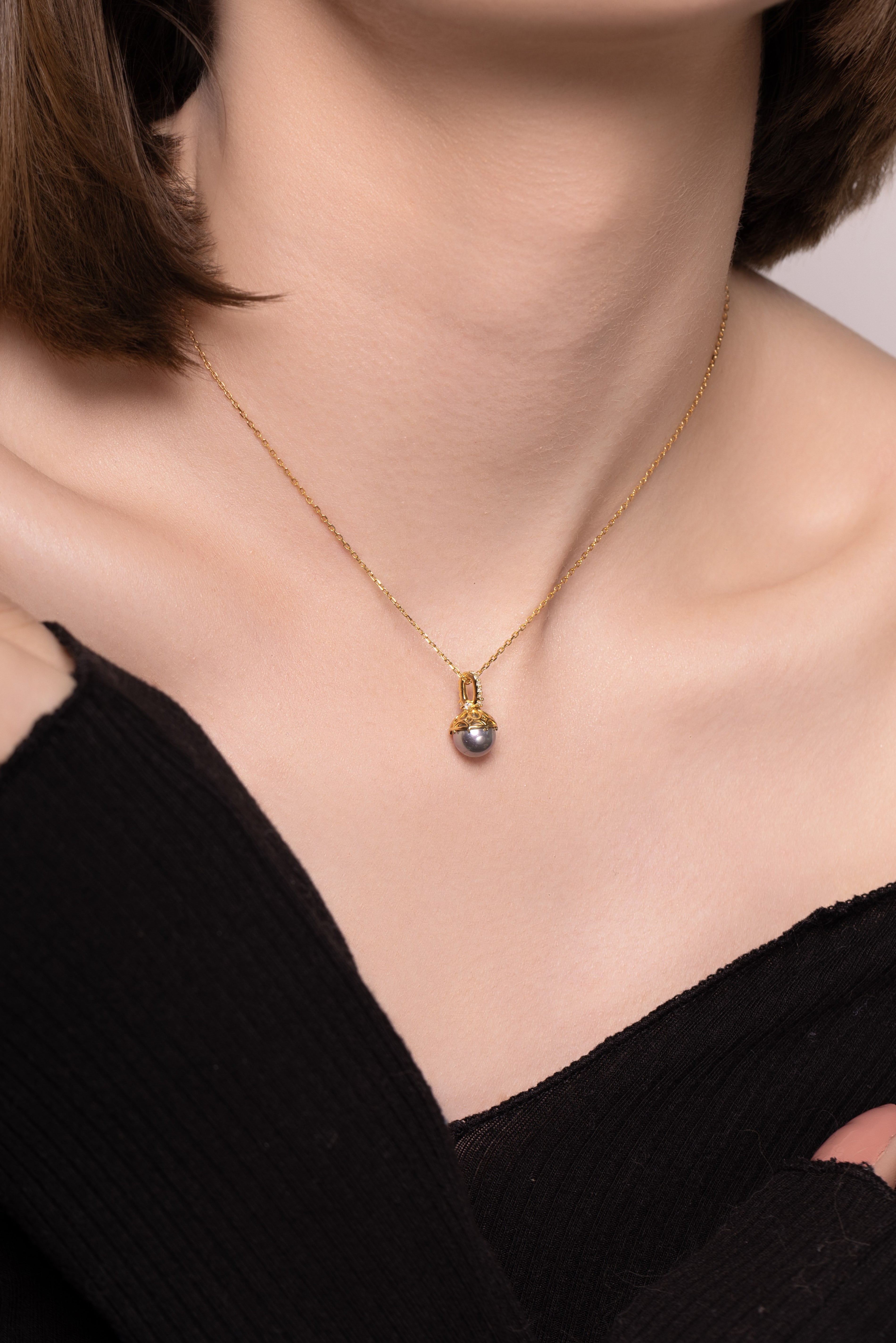 Nik Jewellery Solara 18K gold pearl diamond pendant necklace worn on neck with 16 inch chain, showing fit and length.