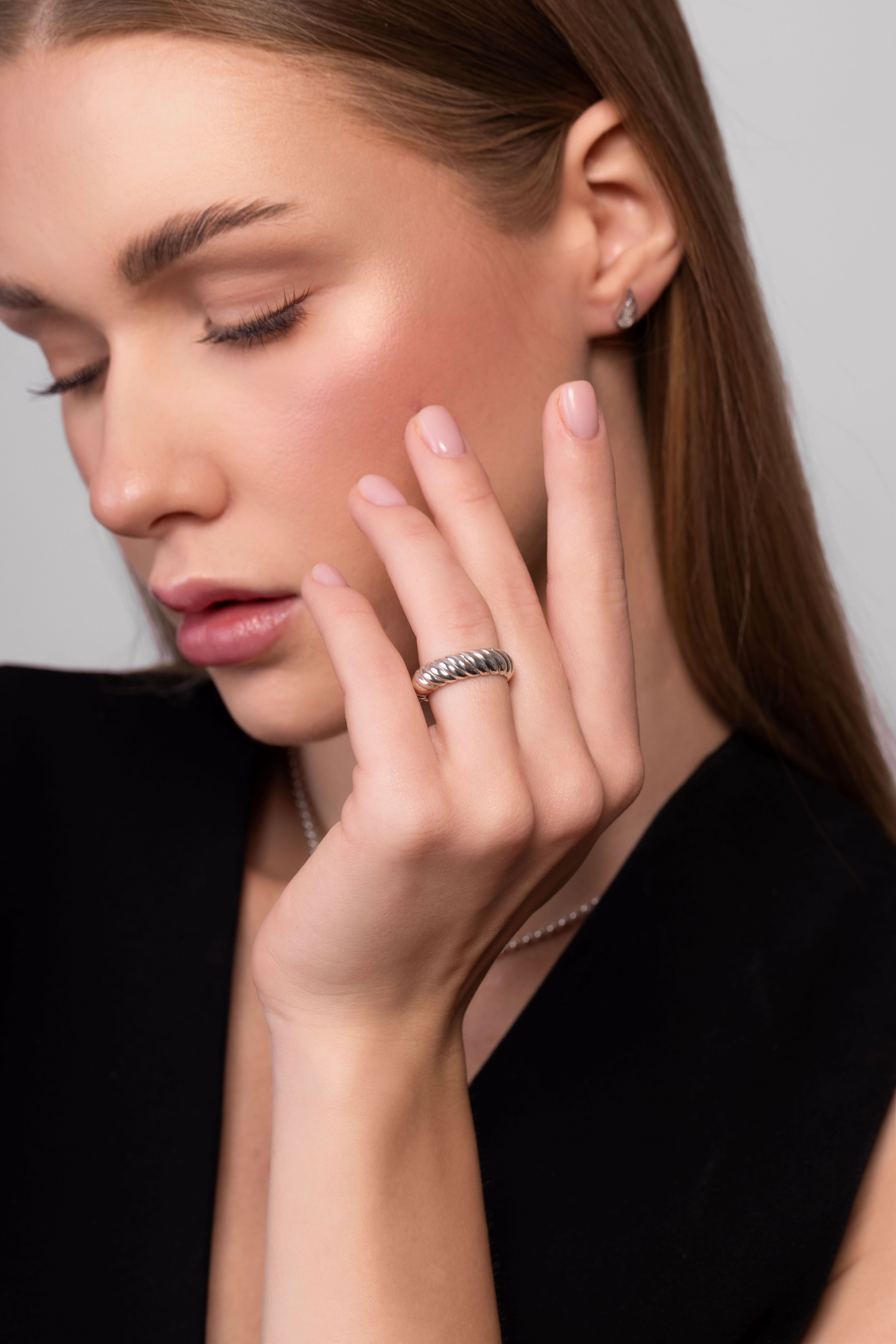 Sterling silver twist ring worn on hand showing textured rope design